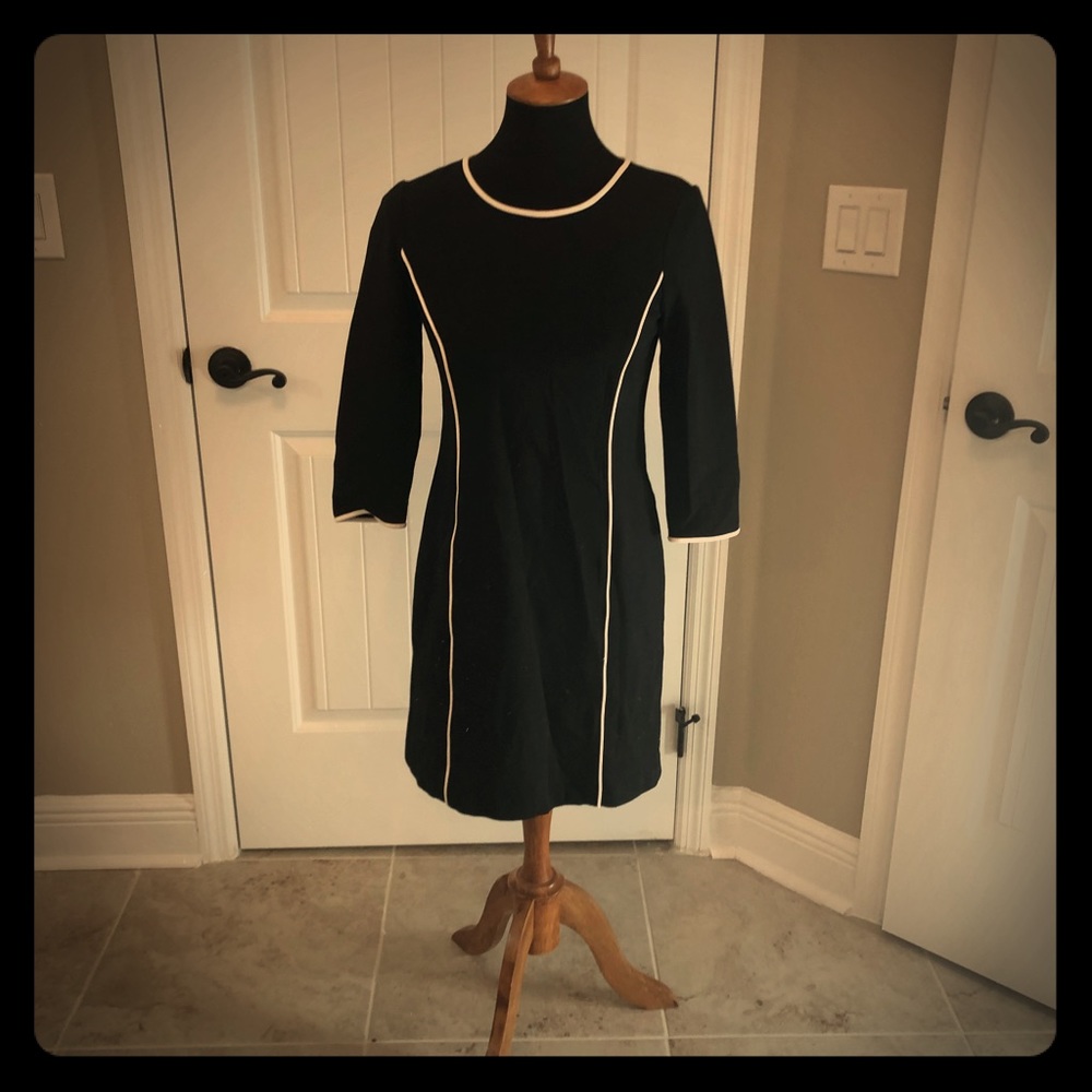 Black dress with white piping.